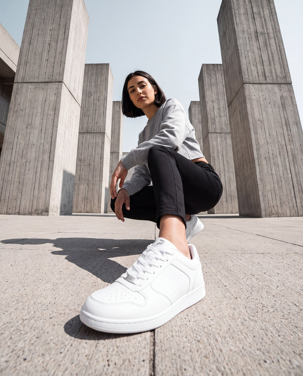 A dancer on a city street corner wearing Flow 2 White dance sneakers